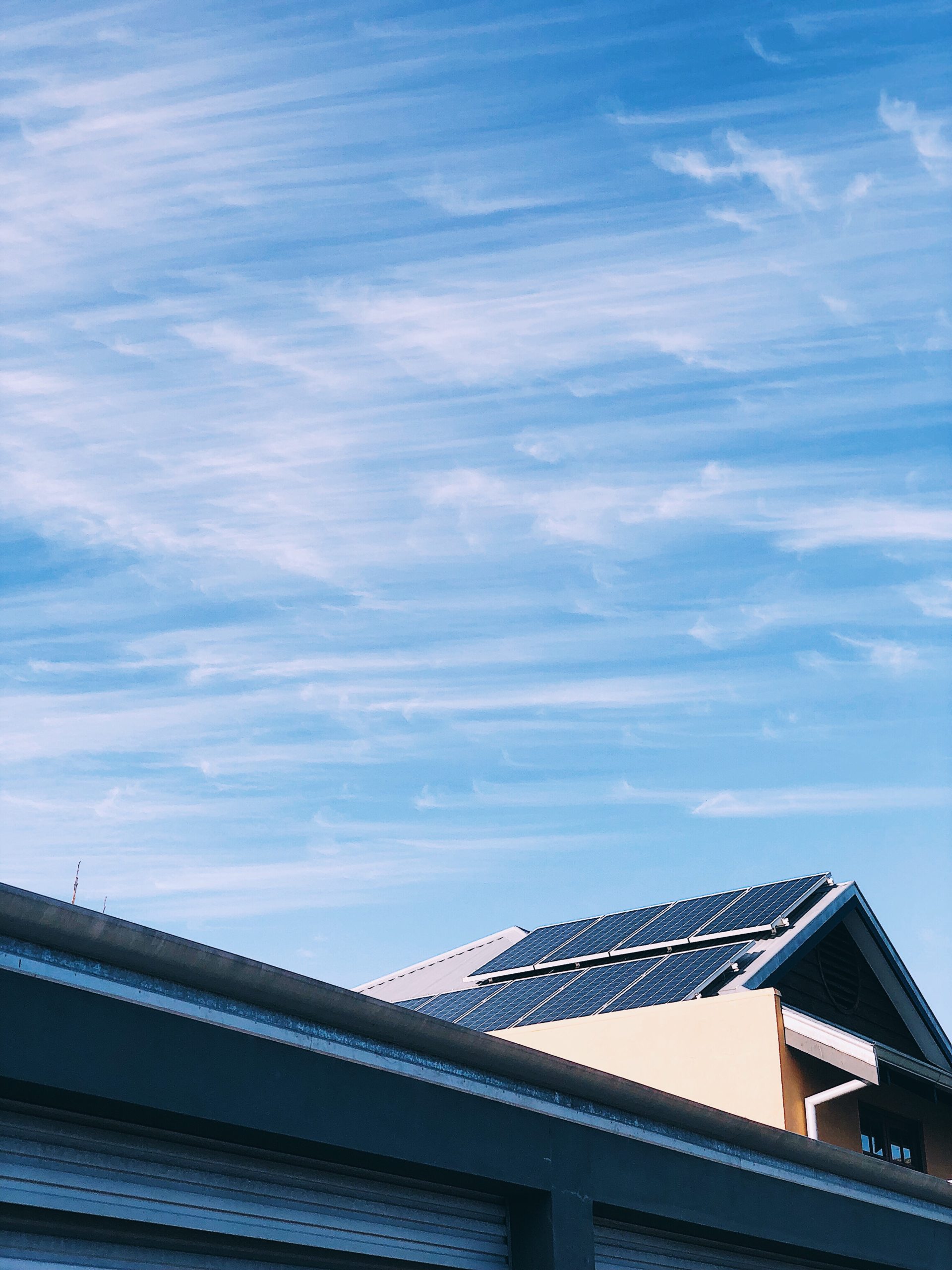 Panneaux solaires installés sur le toit d'une maison sous un ciel serein